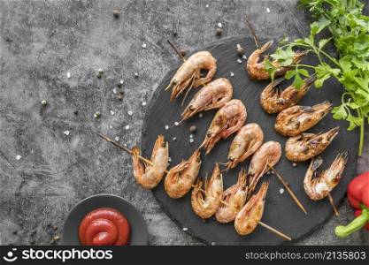 top view shrimp skewers with sauce