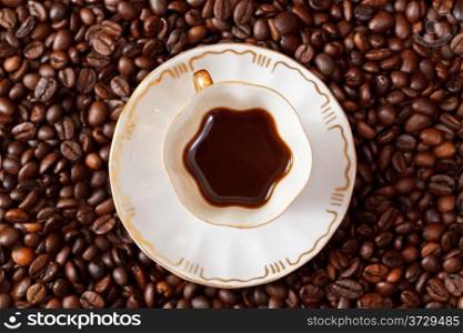 top view small cup of coffee and roasted coffee beans
