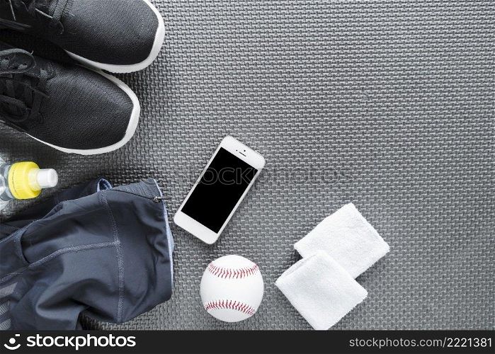 top view smartphone surrounded with sportswear