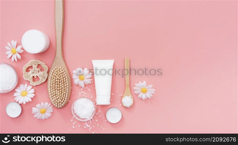 top view spa essentials surrounded by chamomile flowers