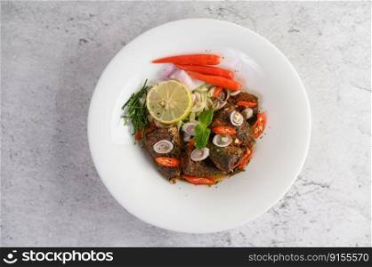 Top view Spicy Canned Sardine Salad with herb ingredient in white dish, copy space