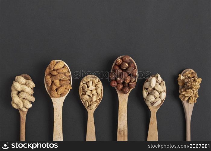 top view spoons with variety nuts