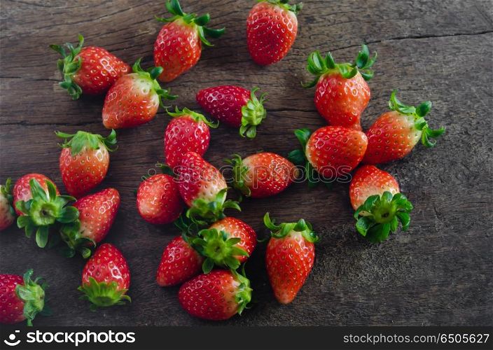 top view still life fresh strawberries over wooden background. strawberries