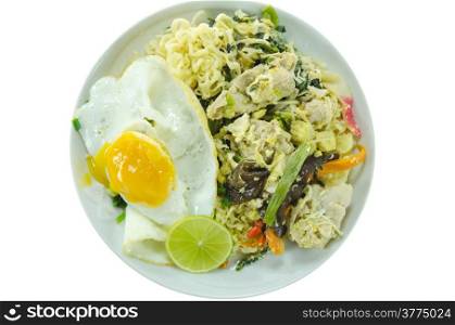 top view stir fried instant noodles with pork , chili , vegetable and fried egg on dish over white background