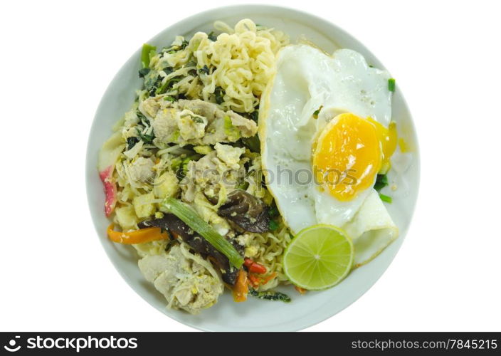 top view stir fried instant noodles with pork , chili , vegetable , slices lime and fried egg on dish over white background
