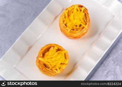 Top view sweet crispy dough with cream filling on white plate. Sweet crispy dough with cream filling on white plate