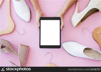 top view tablet surrounded by shoes