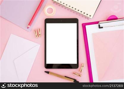top view tablet with pink stationery