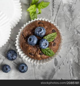 top view tasty cupcake with blueberries mint