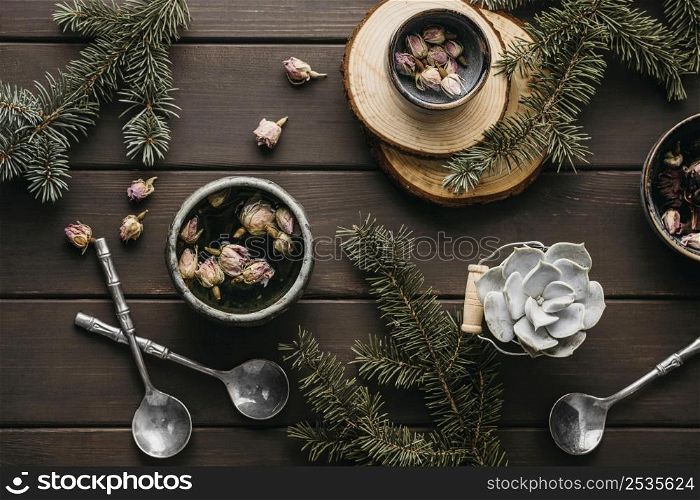 top view tea with dried flowers pine branches