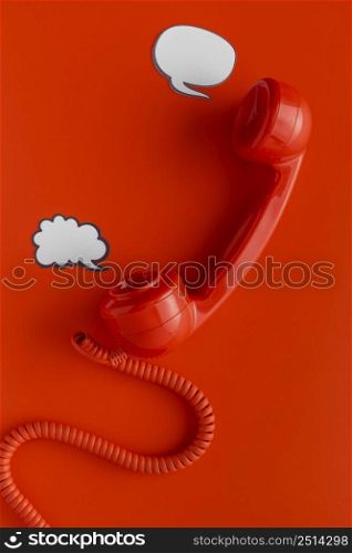 top view telephone receiver with chat bubbles cord