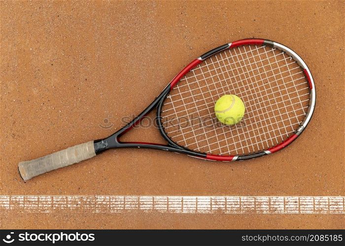 top view tennis ball with racket ground