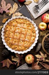 top view thanksgiving apple pie with autumn leaves pine cones