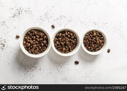 top view three cups with roasted coffee beans