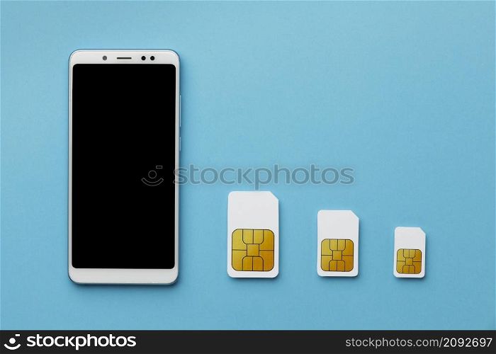top view three sim cards with smartphone copy space