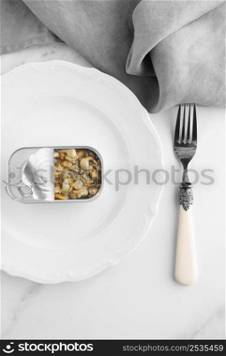 top view tin can with food plate with fork