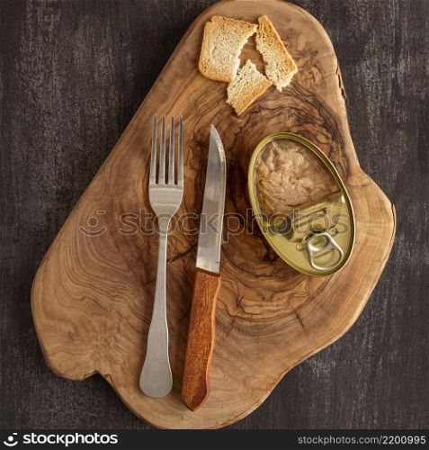 top view tuna can wooden board with cutlery