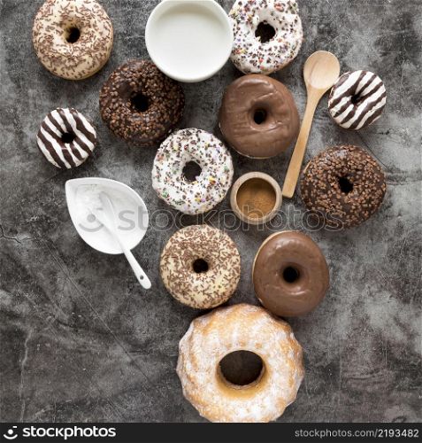 top view variety donuts with milk powdered sugar