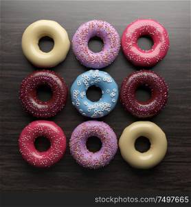 Top view various donut on wooden table . 3d rendering .