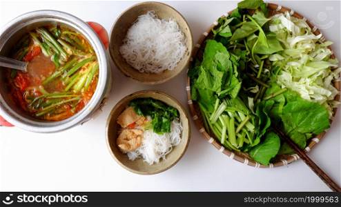 Top view Vietnamese vegan food, green vegetables hot pot homemade from tomato, soy protein, chili sate, leaf mustard, cabbage, bun, spinach, healthy eating that rich fiber, vitamin for vegetarian