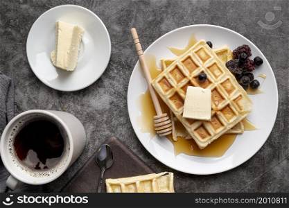 top view waffles plate with butter cup tea