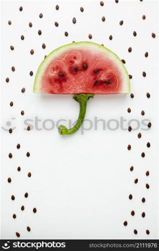top view watermelon umbrella with seeds white background