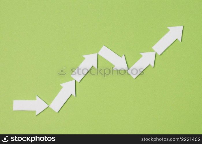top view white arrows green background