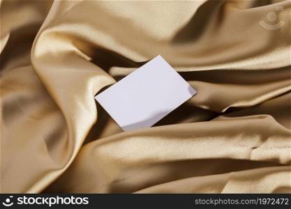 top view white card golden cloth. High resolution photo. top view white card golden cloth. High quality photo
