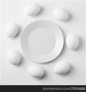 top view white chicken eggs table with plate