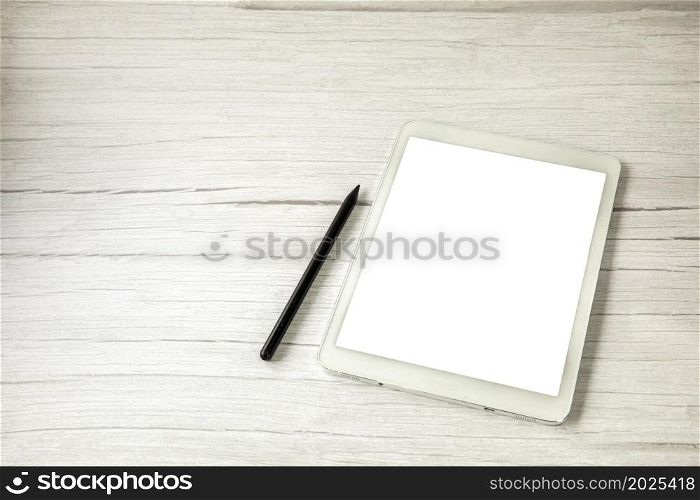 Top view white digital drawing tablet with pen on light wooden desk with copy space, office, home and computer concept space for text. Top view white digital drawing tablet with pen on light wooden desk with copy space, office, home and computer concept