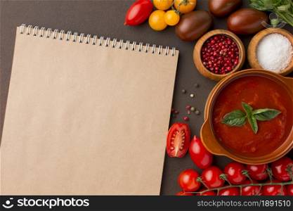 top view winter tomato soup bowl with notebook. Resolution and high quality beautiful photo. top view winter tomato soup bowl with notebook. High quality and resolution beautiful photo concept