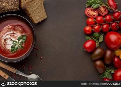 top view winter tomato soup bowl with toast spoons