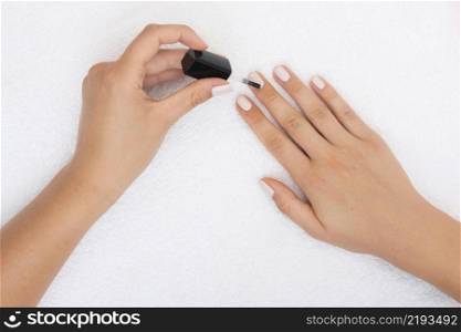 top view woman applying nail polish
