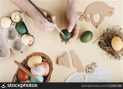 top view woman decorating easter eggs