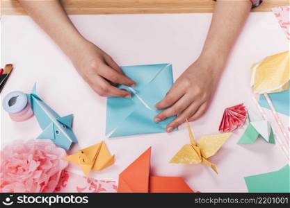 top view woman hand making origami craft table