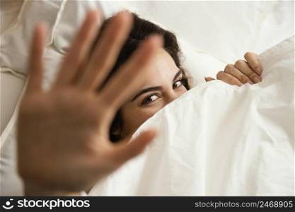top view woman hiding sheets home