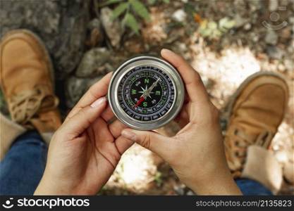top view woman holding compass