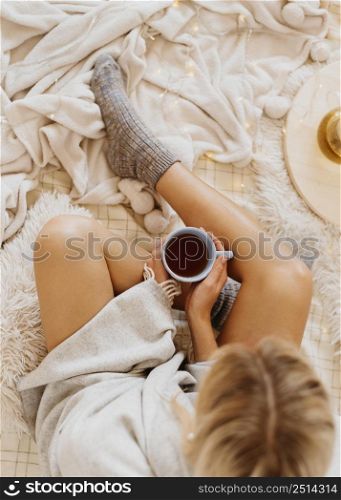 top view woman holding cup tea while enjoying winter holidays