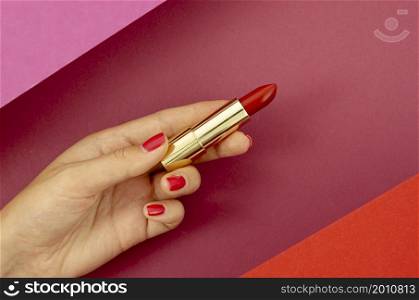 top view woman holding red lipstick