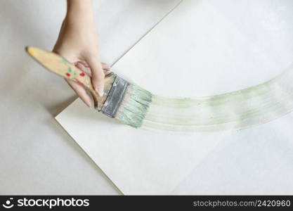top view woman painting with big brush