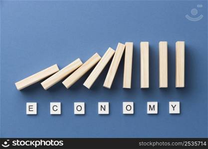 top view wooden pieces arrangement with economy word