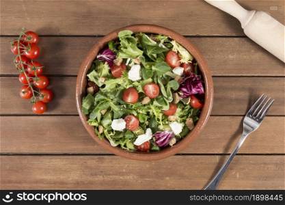 top view wooden surface with delicious salad. Resolution and high quality beautiful photo. top view wooden surface with delicious salad. High quality beautiful photo concept