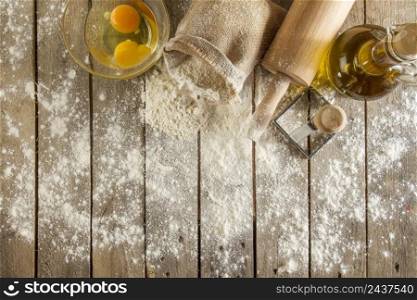 top view wooden surface with flour eggs rolling pin