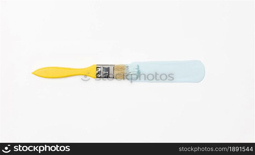 top view yellow brush with blue paint. Resolution and high quality beautiful photo. top view yellow brush with blue paint. High quality and resolution beautiful photo concept