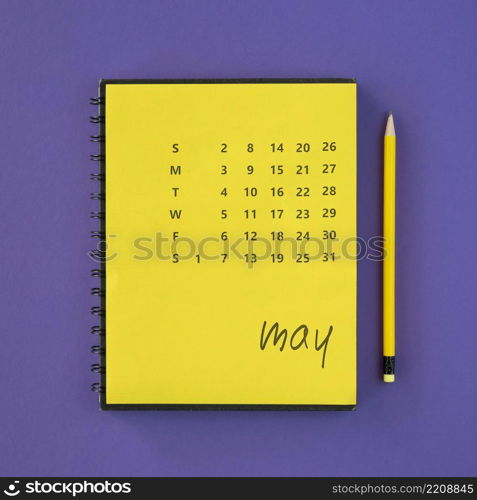 top view yellow calendar pencil
