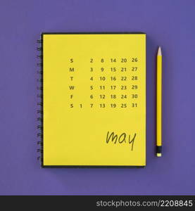 top view yellow calendar pencil