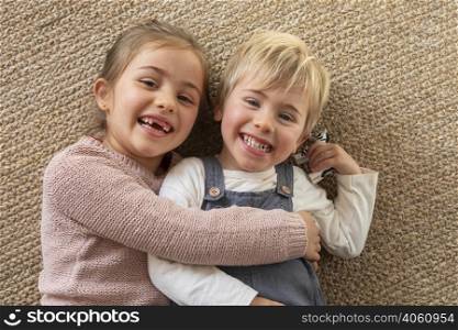 top view young siblings hugging