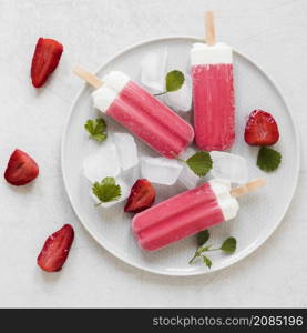 top view yummy popsicles with mint strawberries