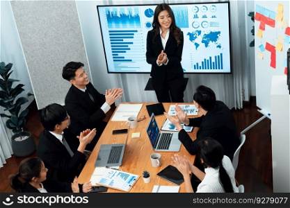Top widen view of confidence of company presentation on financial analyzed by business intelligence in dashboard report with businesspeople in boardroom meeting to promote harmony in workplace concept. Confidence and young asian businessman give presentation to promote harmony.