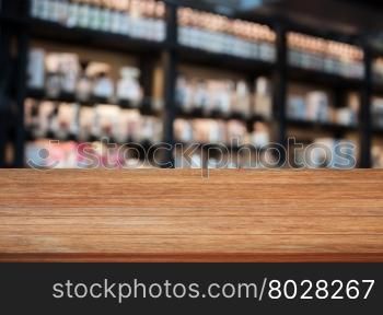Top wooden table in coffee shop blurred background with bokeh